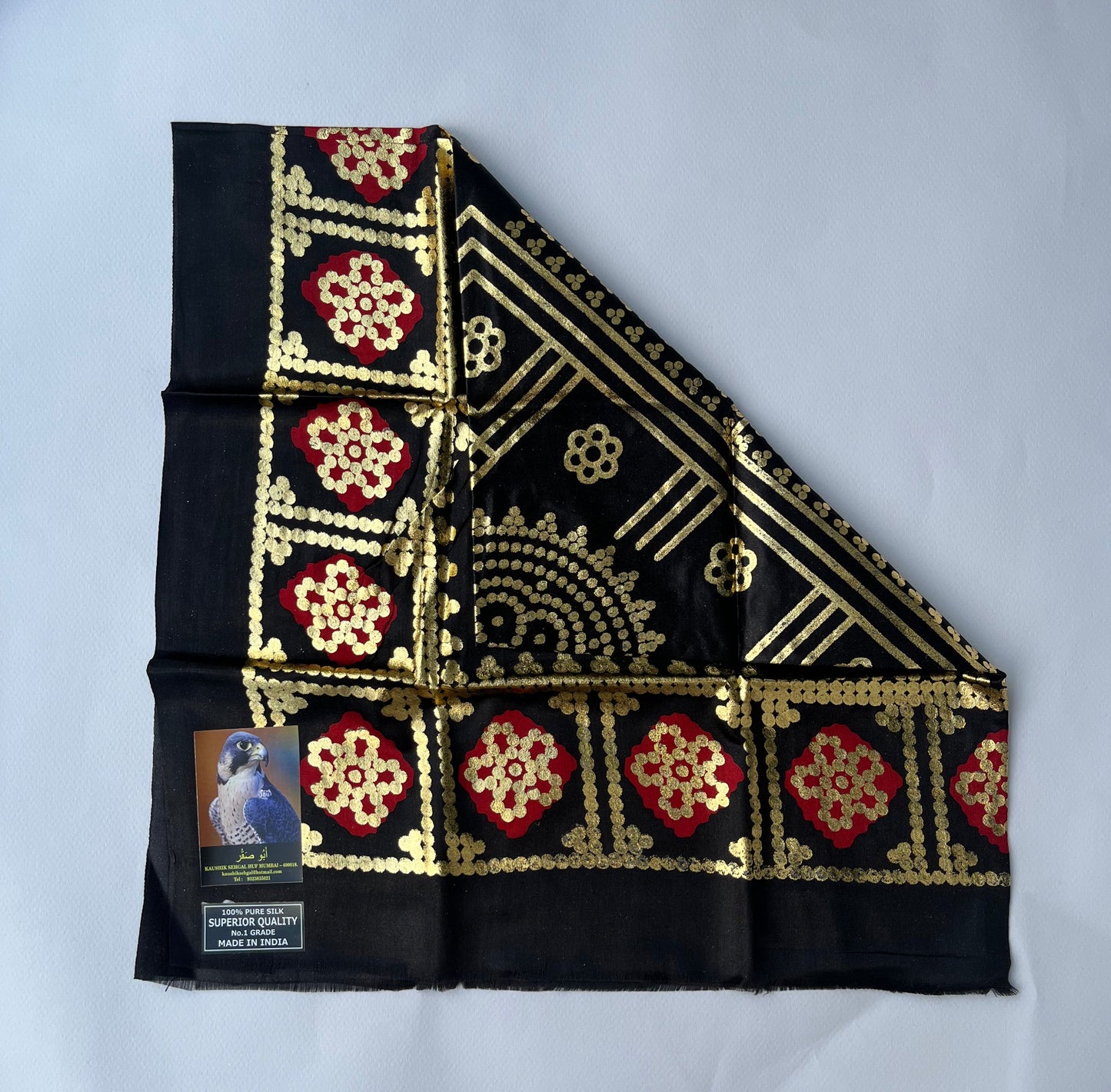 Black fabric with gold and red patterns.