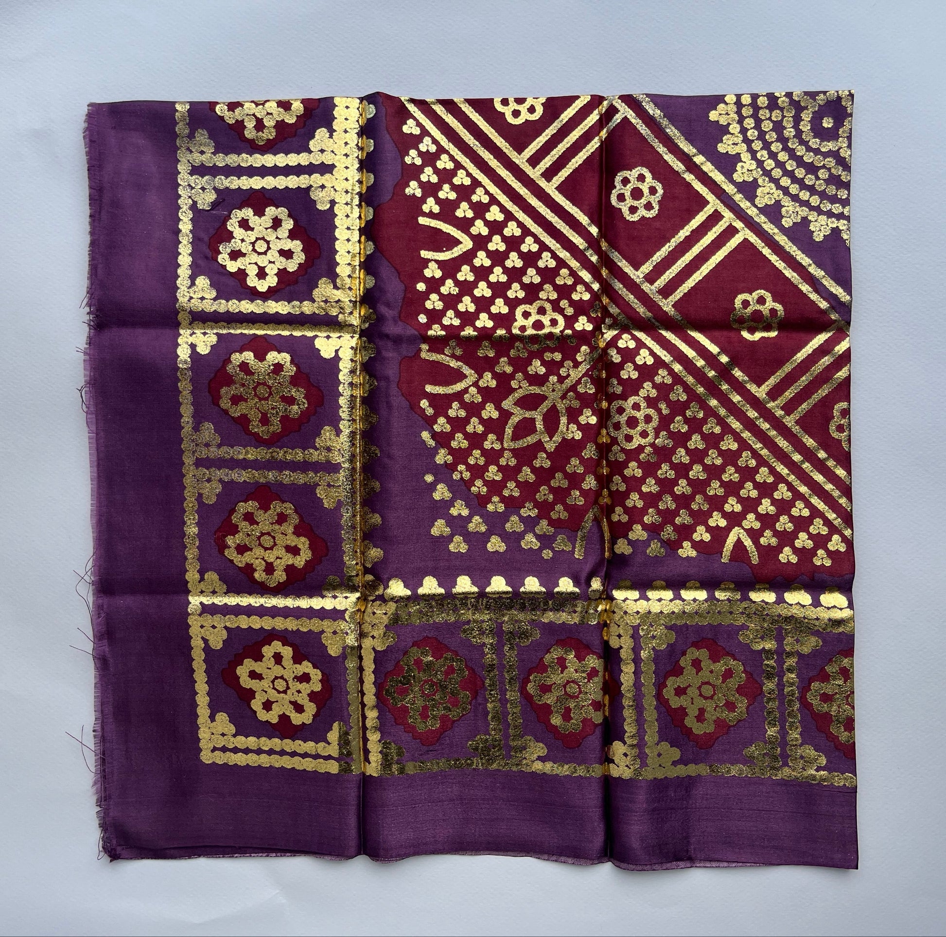 Purple fabric with gold intricate.patterns 